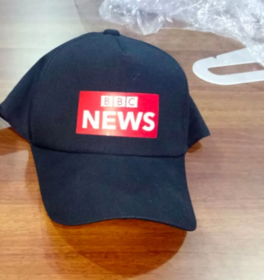 Black cap screen printed with the red BBC News logo