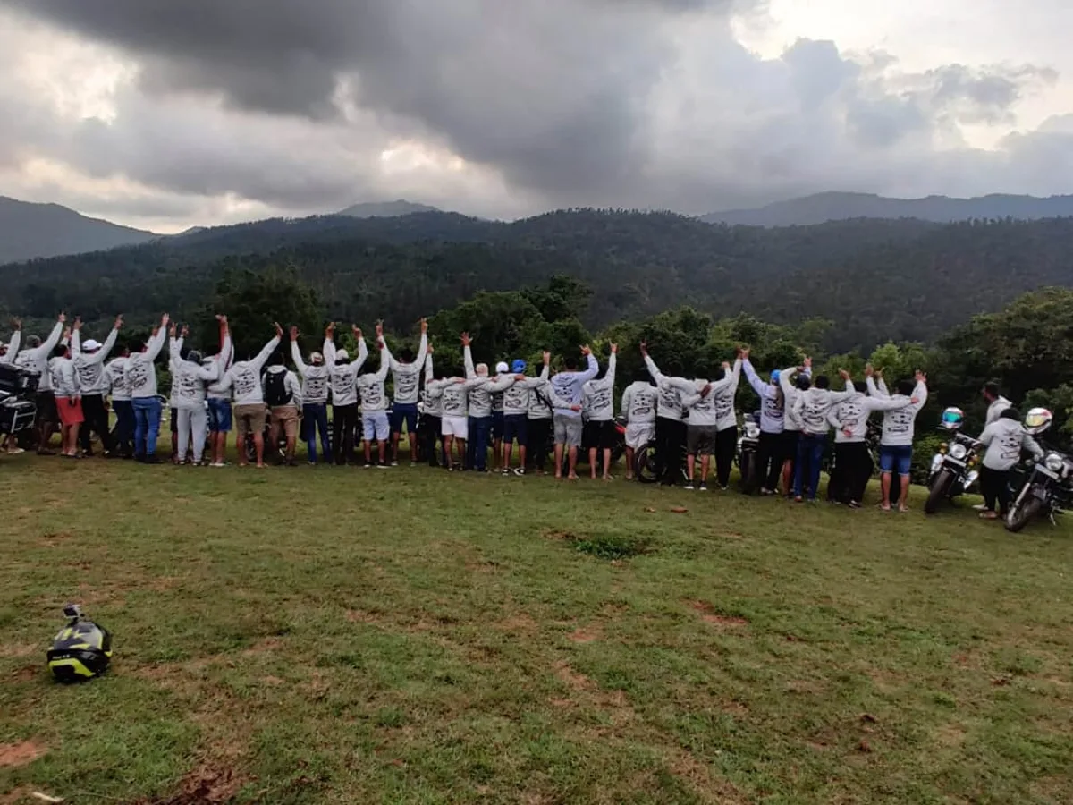 Captain Bulls riders wearing screen-printed white hoodies with their motorcycles at a hilltop reunion ride
