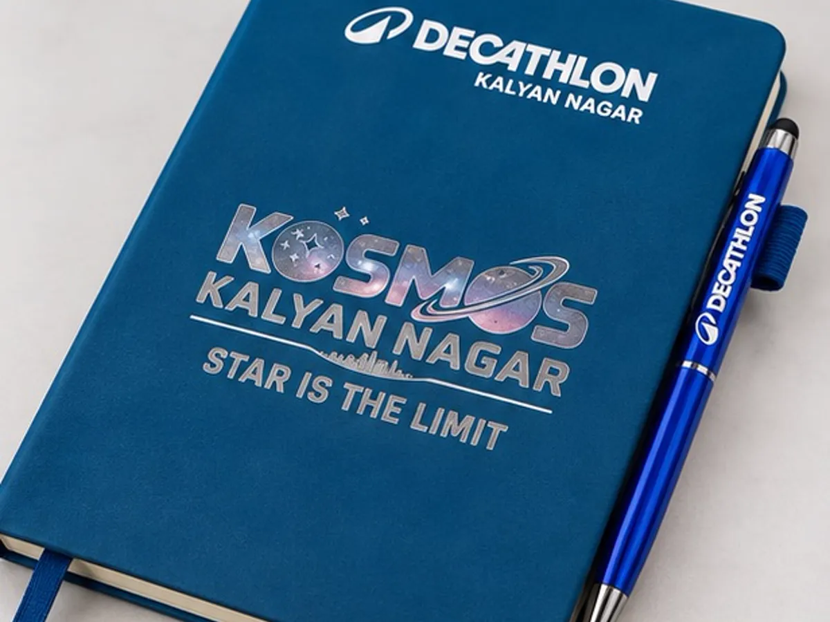 Angled view of the printed Decathlon Kalyan Nagar diary and branded pen