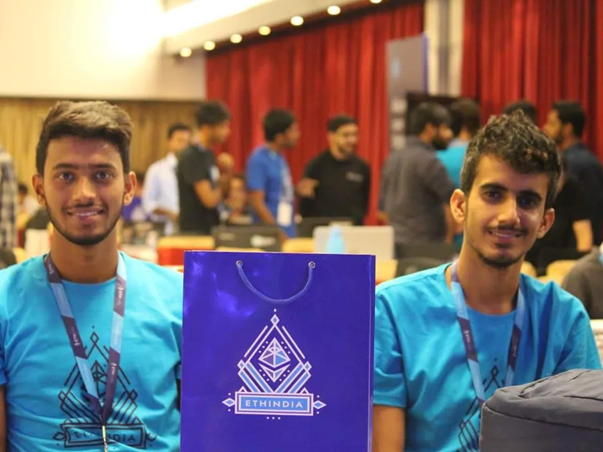 Participants with Devfolio printed event T-shirts and a branded paper bag
