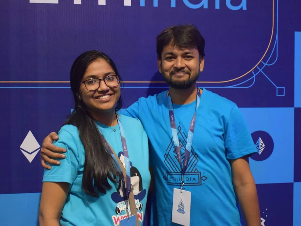 Event organisers wearing Devfolio printed T-shirts and branded lanyards