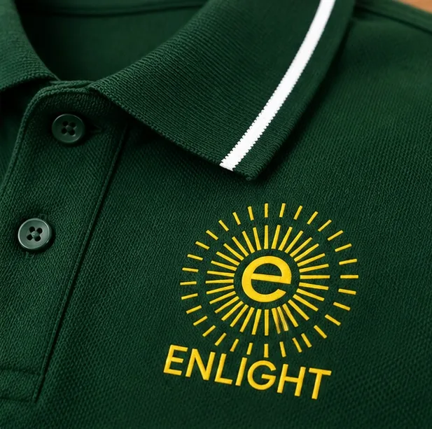 Close-up of the yellow screen printed Enlight sunburst logo on a green cotton polo T-shirt