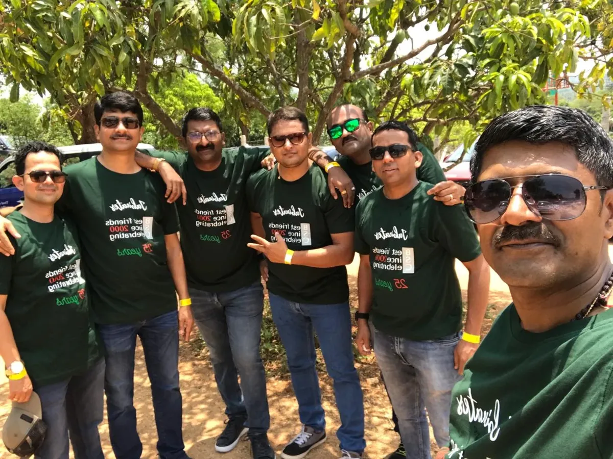 Group wearing dark green screen printed Friends Get Together reunion T-shirts