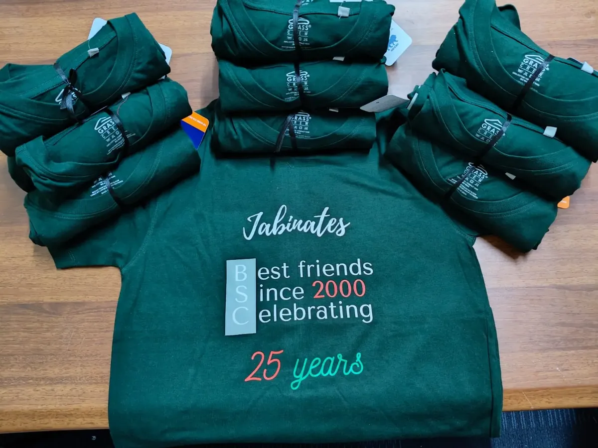 Folded dark green Friends Get Together T-shirts with the screen printed reunion artwork on top