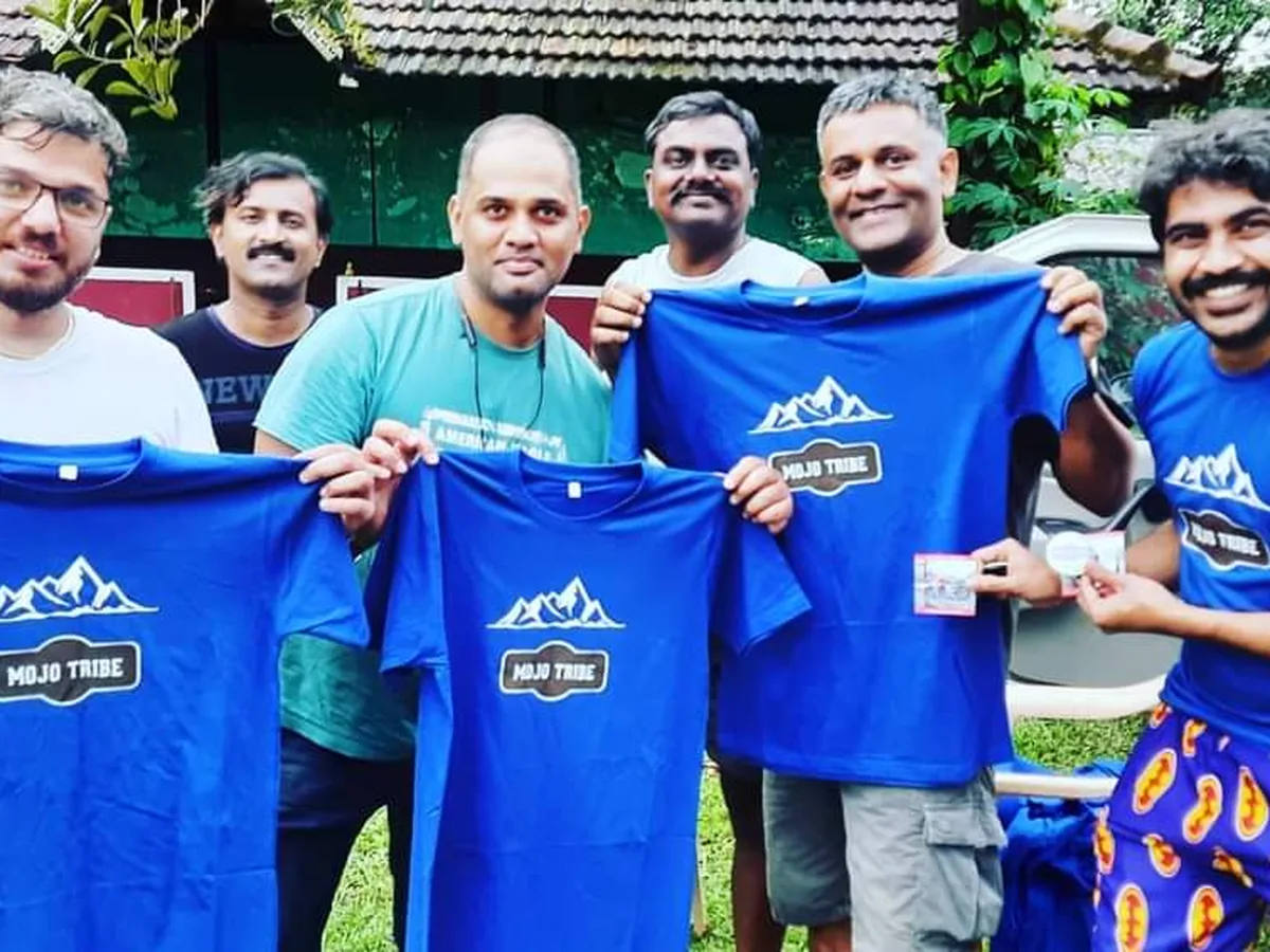 Blue Mojo Tribe cotton T-shirts with white screen printed mountain logo held up by riders