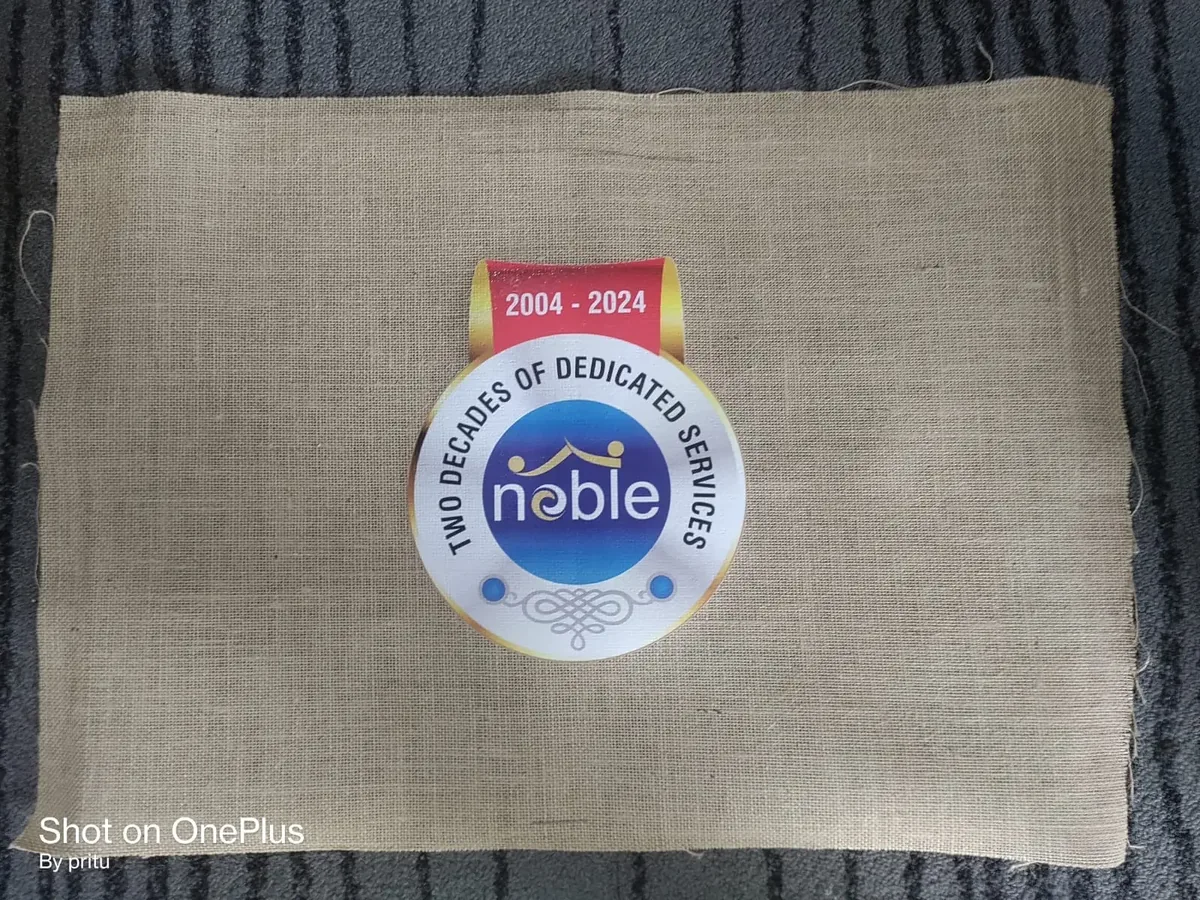 Jute bag panel DTF printed with the Nobel two decades of dedicated services badge
