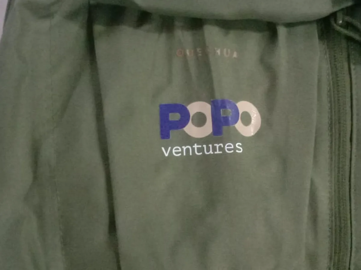 Olive green bag branded with the Popo Ventures logo