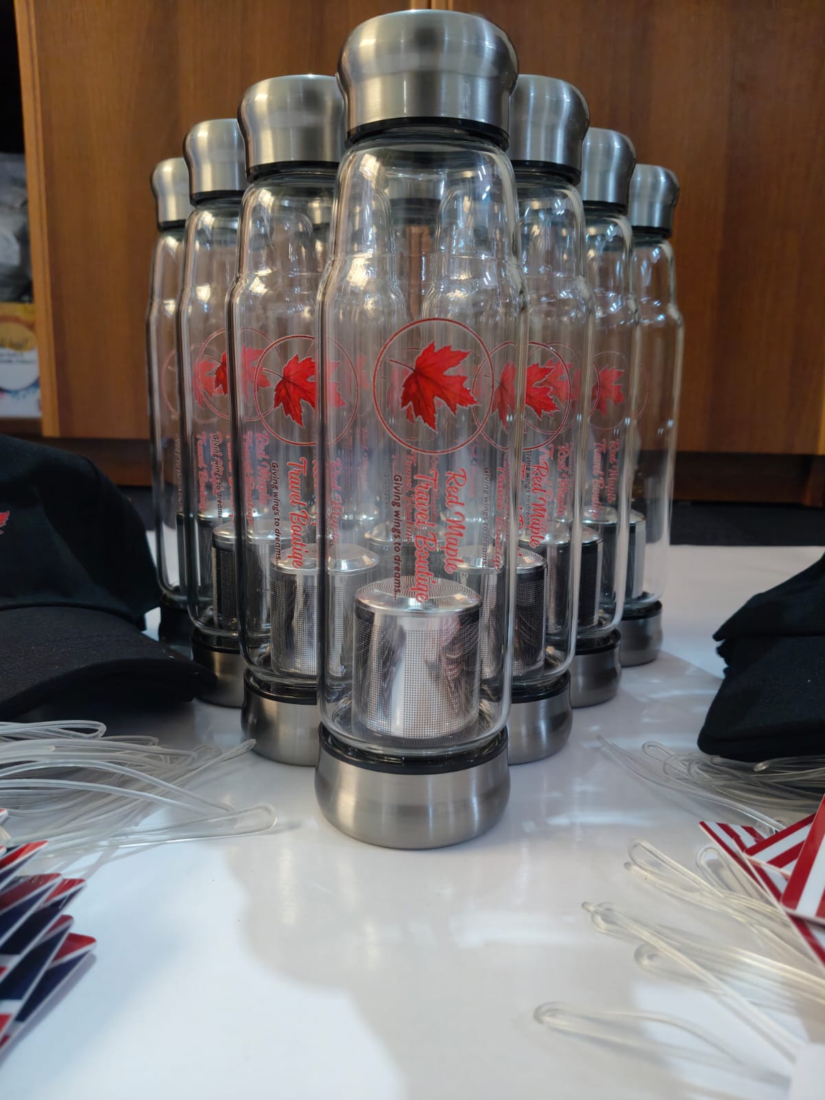 Glass and steel bottles with the red maple leaf Red Maple Travel Boutique branding