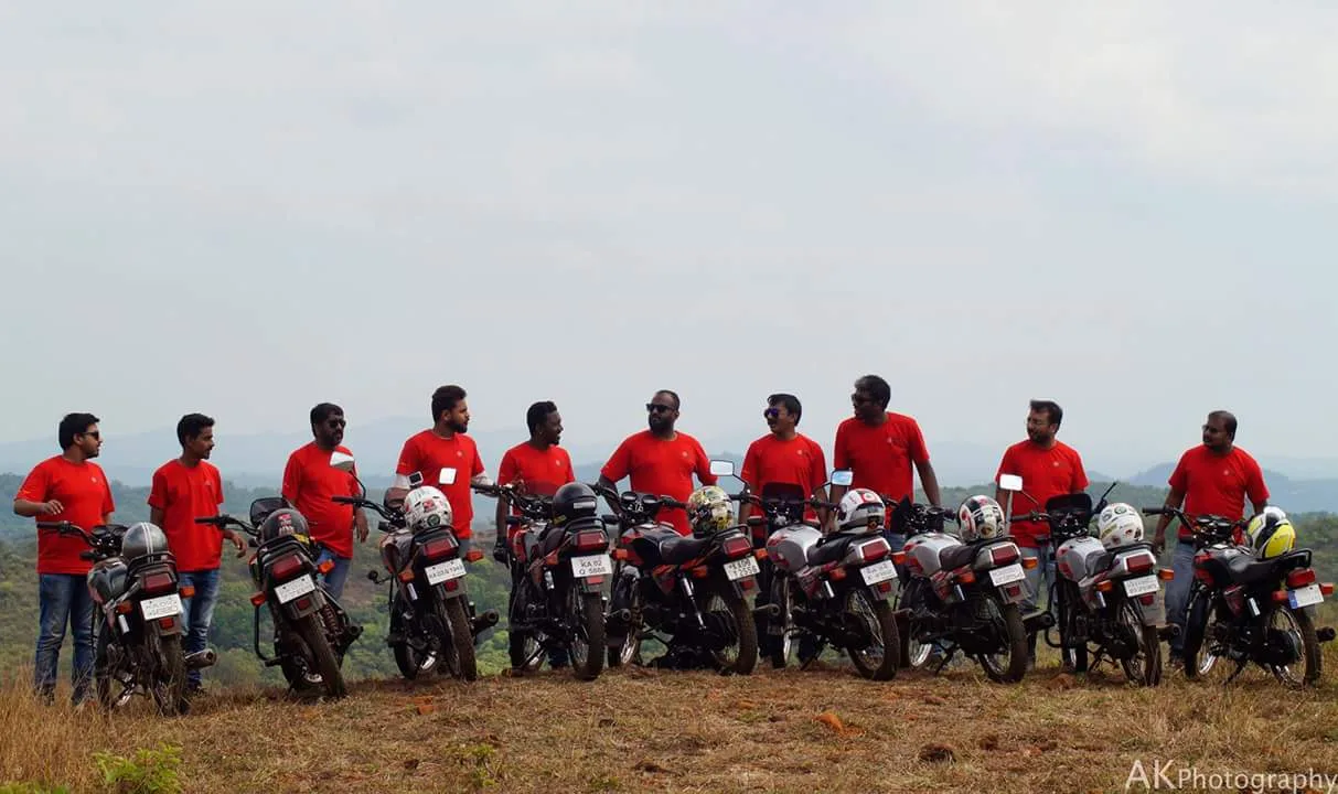 Riders standing with their motorcycles wearing red Shogun Club screen printed cotton T-shirts