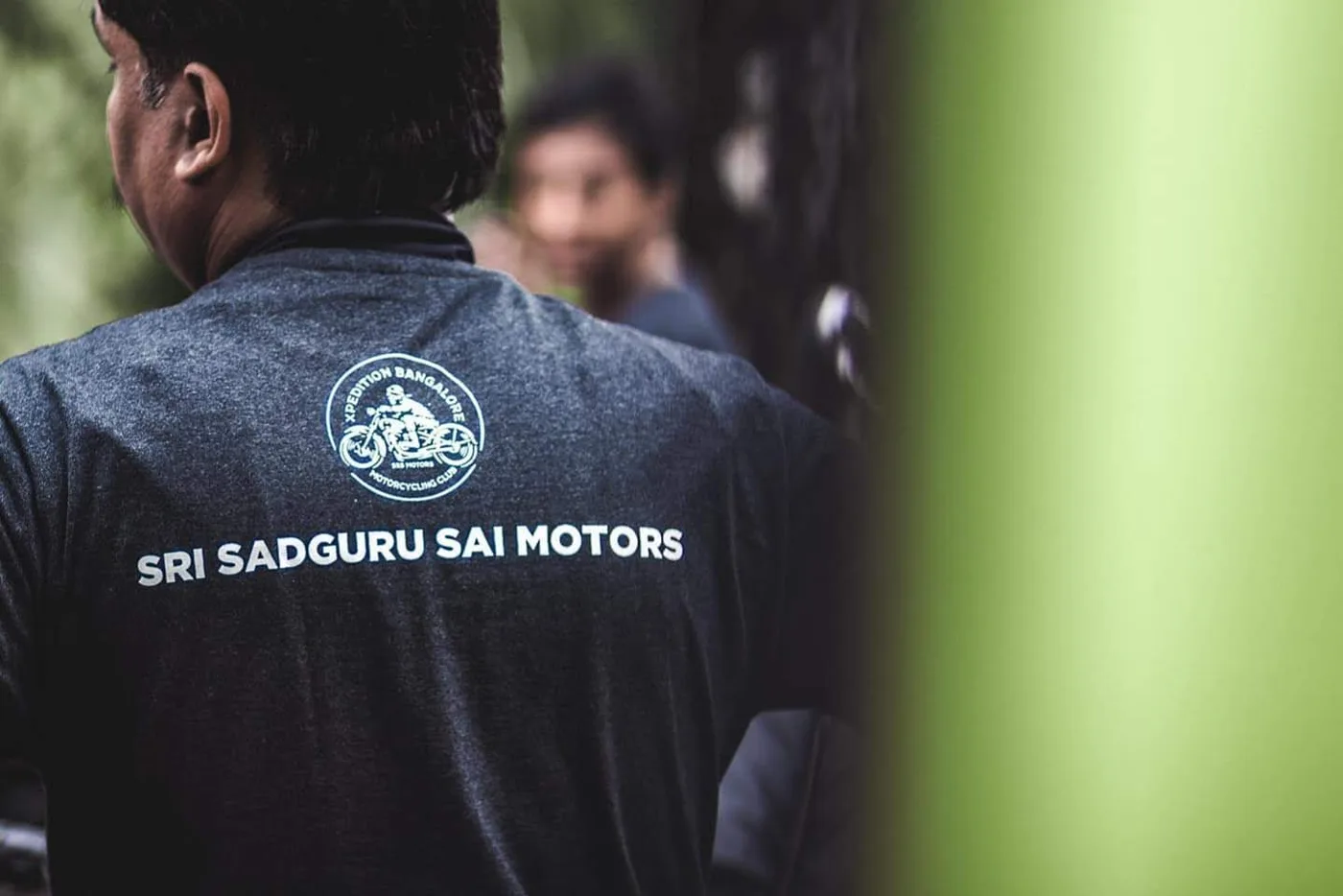 Back of a dark grey T-shirt with the DTF printed Sri Sadguru Sai Motors motorcycling club design