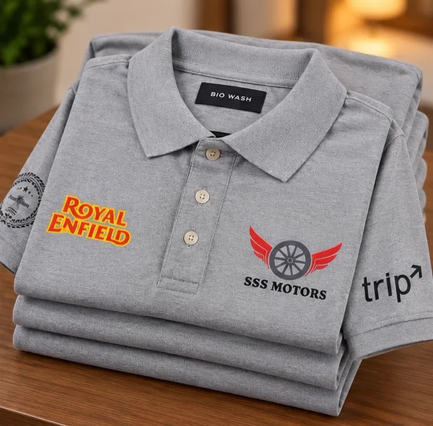 Folded stack of grey SSS Motors screen printed polo T-shirts