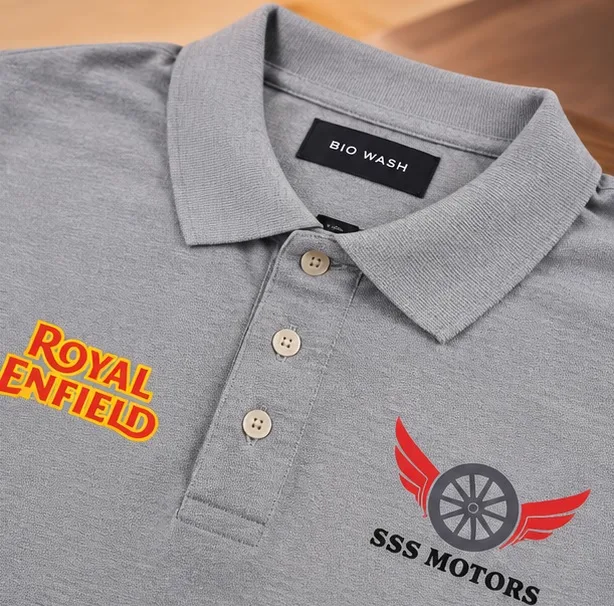 Close-up of the screen printed SSS Motors and Royal Enfield chest logos on the grey polo