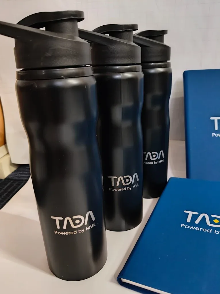 Close-up of the engraved TADA logo on the black bottles