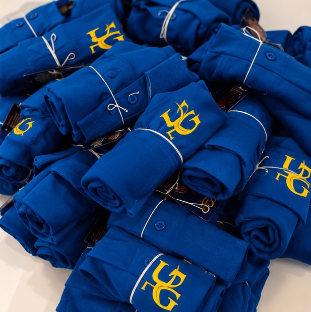 Rolled and packed royal blue Udupi Grand polo T-shirts ready for delivery
