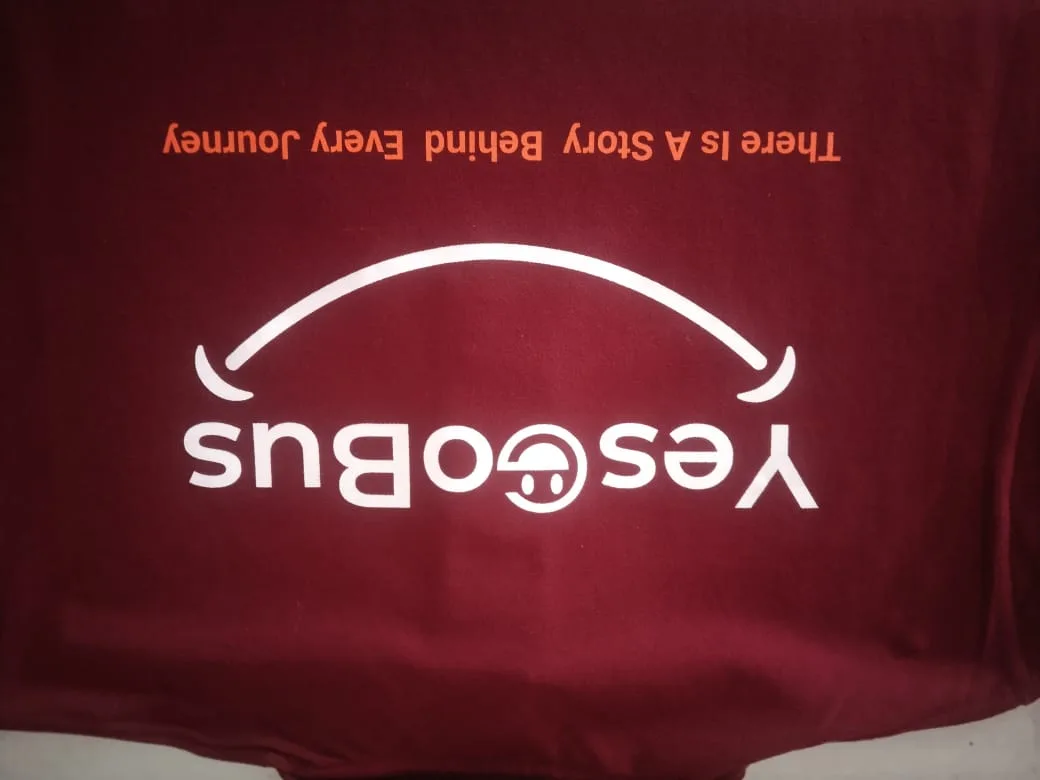 Maroon Yes Go Bus T-shirt with the white screen printed logo and tagline